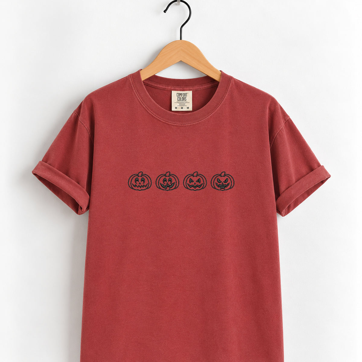 Jack-o-lantern embroidered tee in Chili on a wooden hanger