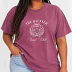 Woman with braids wearing The Haunted Social Club crest tee in Berry