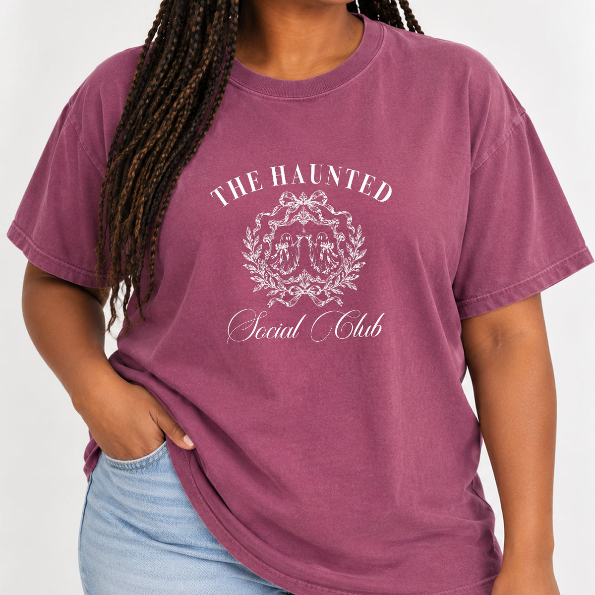 Woman with braids wearing The Haunted Social Club crest tee in Berry
