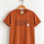 Boo embroidered tee in Yam (burnt orange) on a wooden hanger, varsity BOO outline stitching with a small ghost