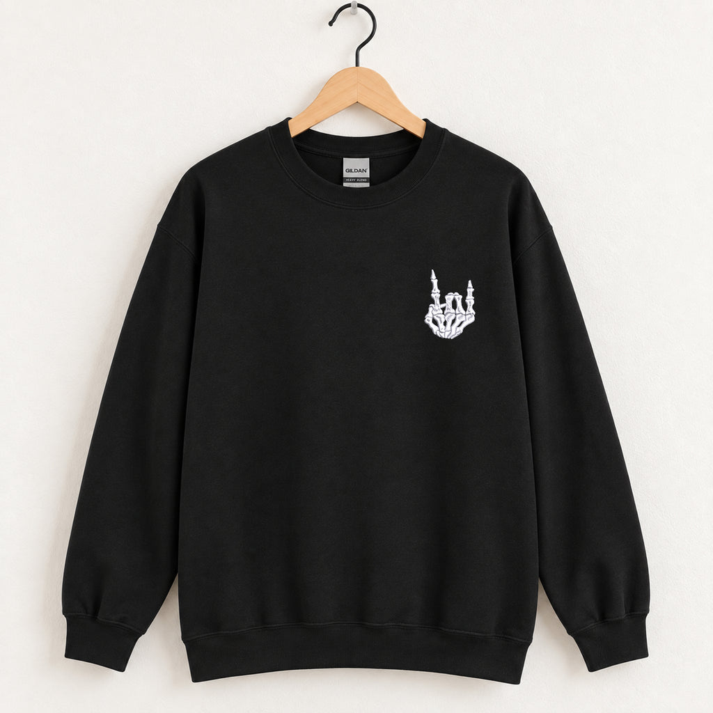 Rock On Skeleton Hand embroidered crewneck sweatshirt in Black on a wooden hanger, white thread rock-on skeleton hand on the left chest