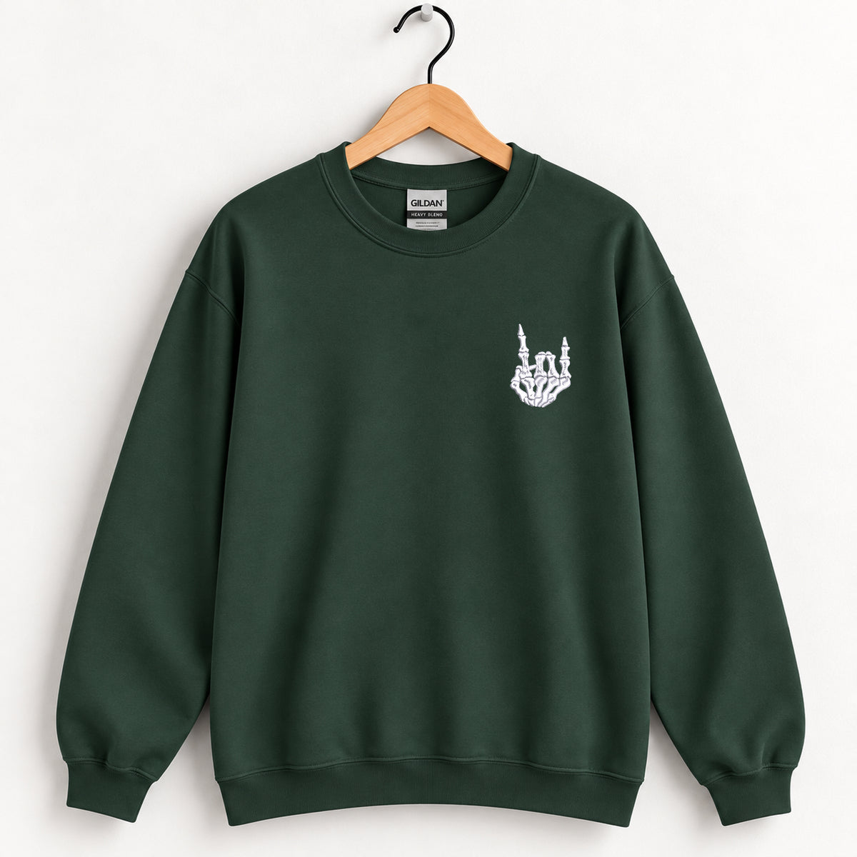 Rock On Skeleton Hand embroidered crewneck sweatshirt in Forest Green on a wooden hanger