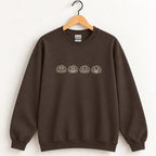 Jack-o-lantern embroidered crewneck sweatshirt in Dark Chocolate on a wooden hanger