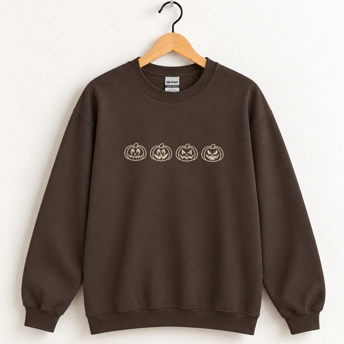 Jack-o-lantern embroidered crewneck sweatshirt in Dark Chocolate on a wooden hanger