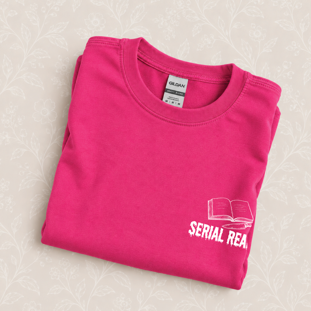Serial Reader crewneck sweatshirt folded on a cream floral surface, close up of the book and knife design