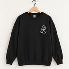 Ghost with a drink embroidered crewneck sweatshirt in Black on a wooden hanger
