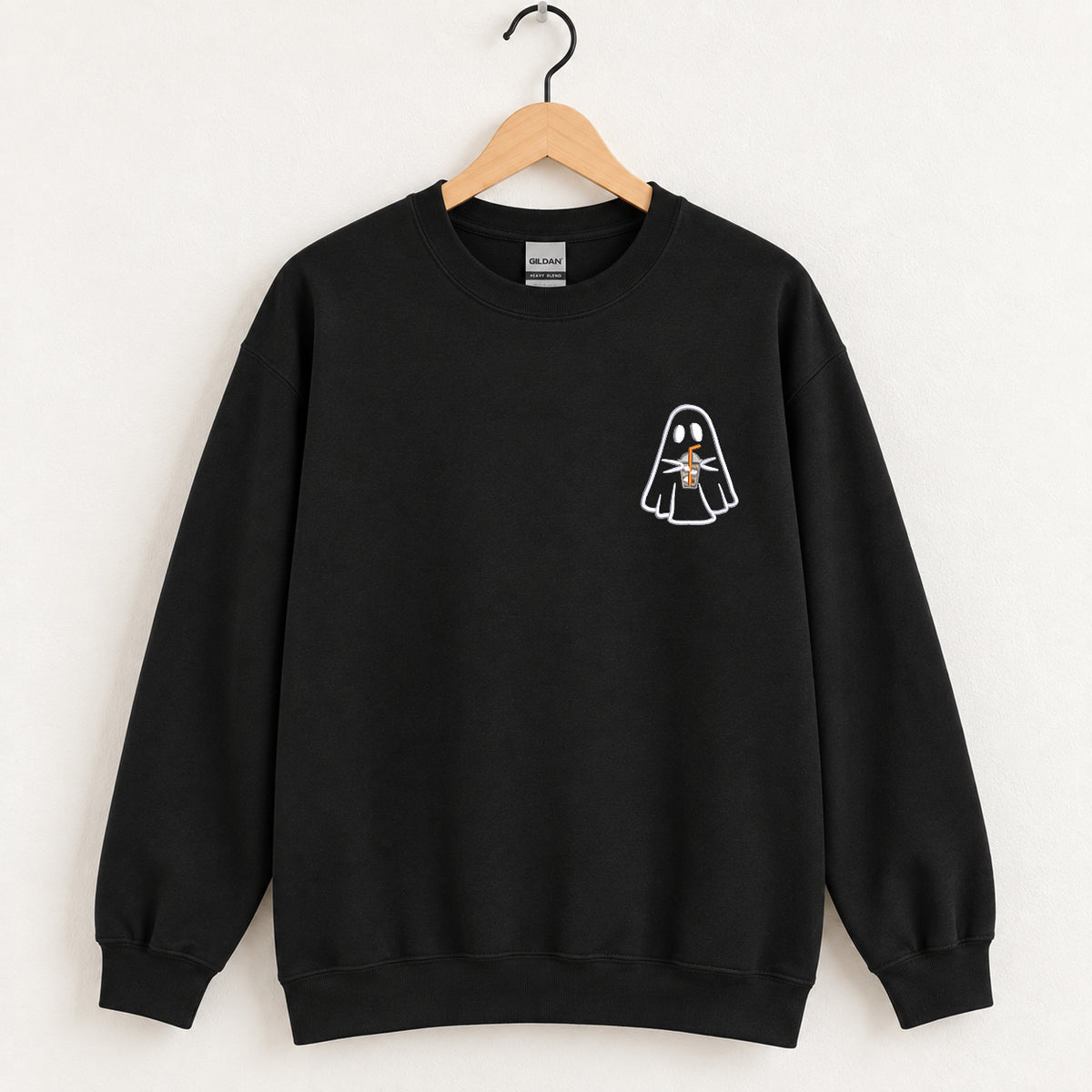 Ghost with a drink embroidered crewneck sweatshirt in Black on a wooden hanger