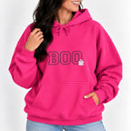 Woman wearing the Boo embroidered hoodie in Heliconia pink with jeans