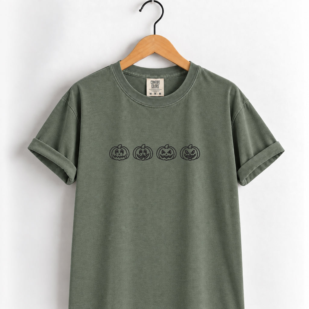 Jack-o-lantern embroidered tee in Moss on a wooden hanger