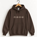 Jack-o-lantern embroidered hoodie in Dark Chocolate on a wooden hanger, ivory thread pumpkins