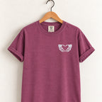 Heart hands skeleton embroidered tee in Berry on a wooden hanger