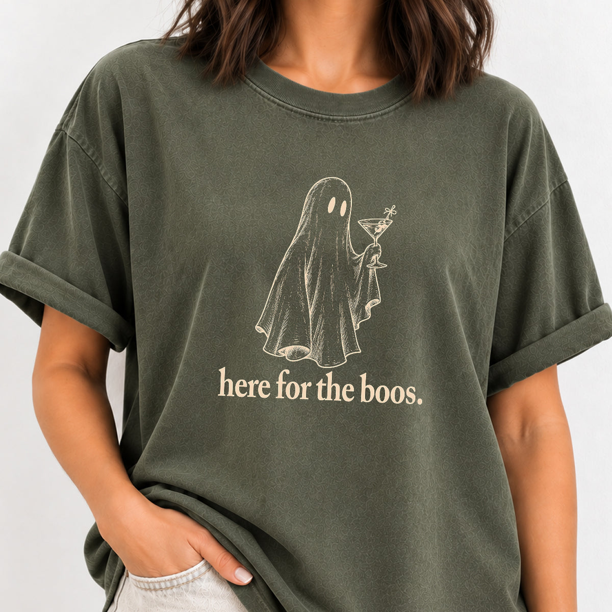 Woman wearing the Here for the Boos ghost martini tee in Moss