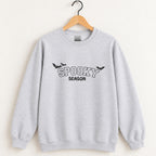 Spooky Season embroidered crewneck sweatshirt in Ash on a wooden hanger, black thread