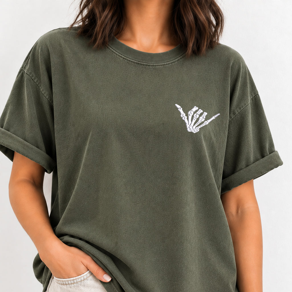 Woman wearing the shaka skeleton hand embroidered tee in Moss