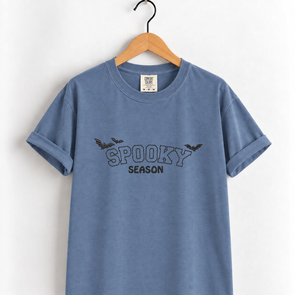 Spooky Season embroidered tee in Blue Jean on a wooden hanger