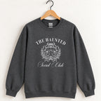 The Haunted Social Club crewneck sweatshirt in Dark Heather on a wooden hanger