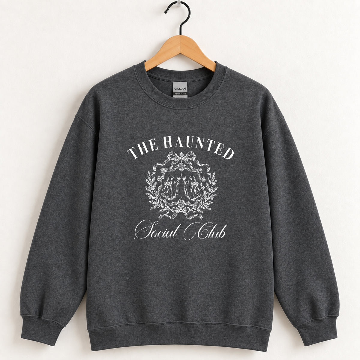 The Haunted Social Club crewneck sweatshirt in Dark Heather on a wooden hanger