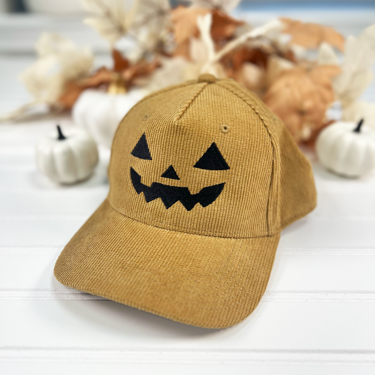 Jack-o-lantern embroidered corduroy snapback hat in Khaki with a black thread pumpkin face