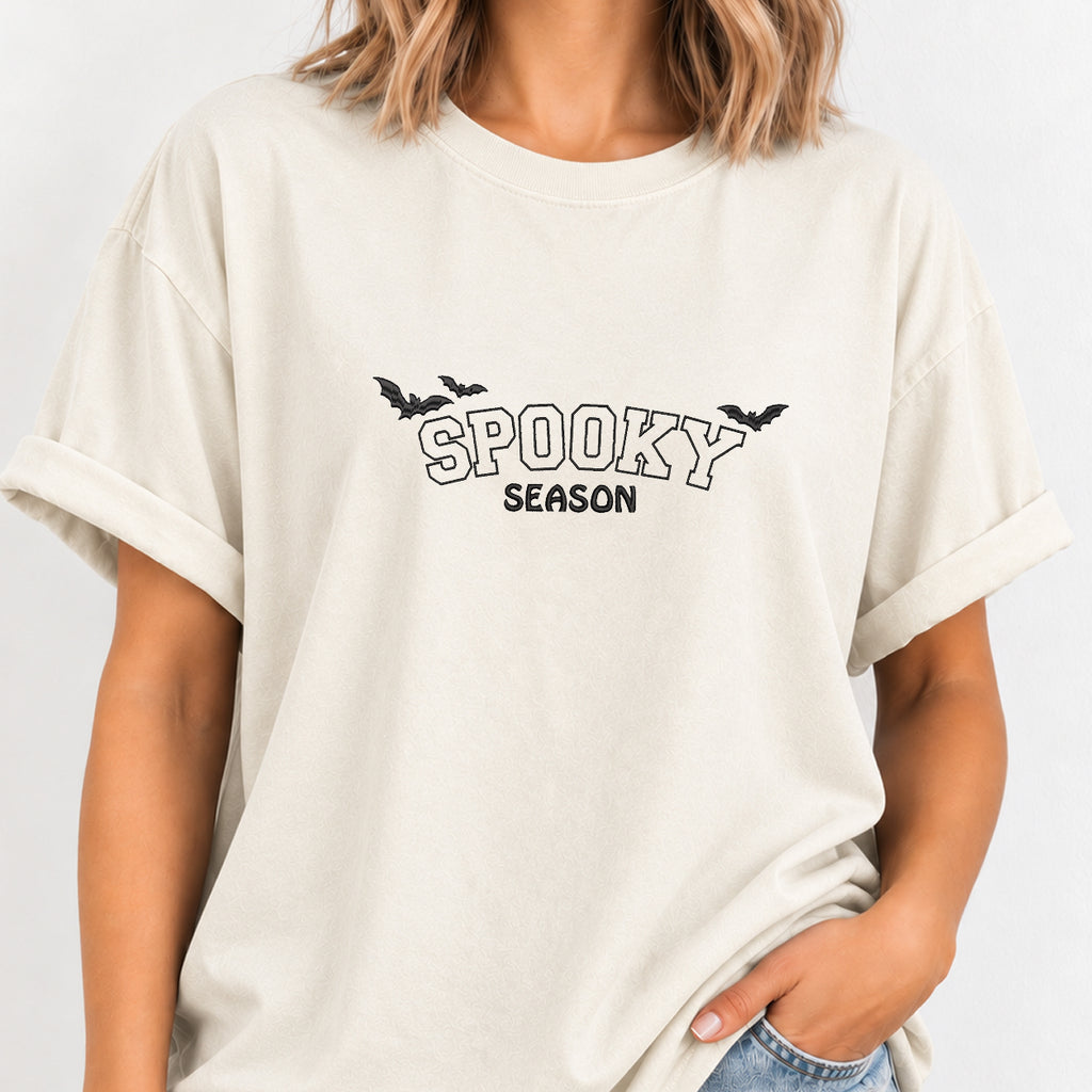 Woman wearing the Spooky Season embroidered bats tee in Ivory