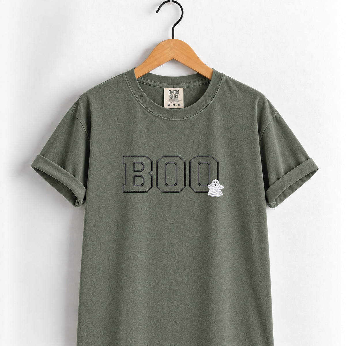 Boo embroidered tee in Moss on a wooden hanger, varsity BOO outline stitching with a small ghost