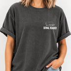 Woman wearing the Serial Reader left chest book tee in Pepper