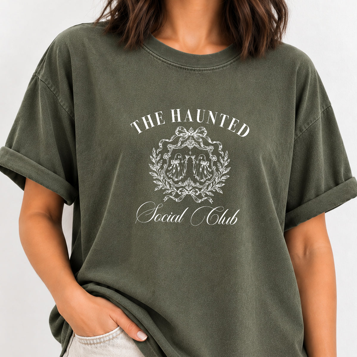 Woman wearing The Haunted Social Club crest tee in Moss