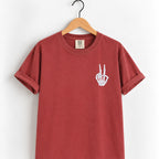 Peace sign skeleton hand embroidered tee in Chili on a wooden hanger