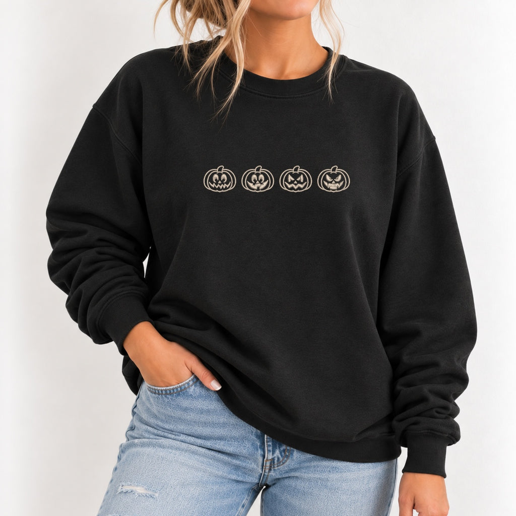 Woman wearing the jack-o-lantern embroidered crewneck sweatshirt in Black with jeans