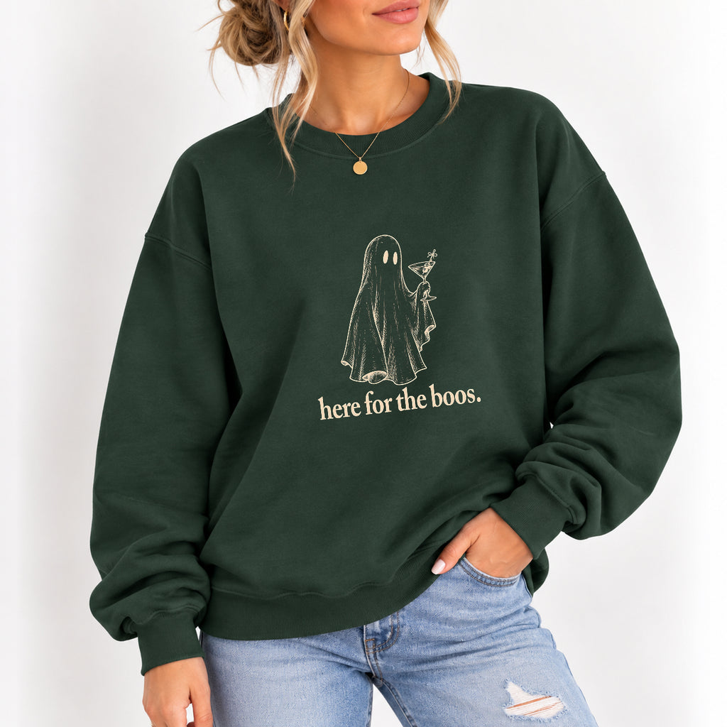 Woman wearing the Here for the Boos crewneck sweatshirt in Forest Green with jeans