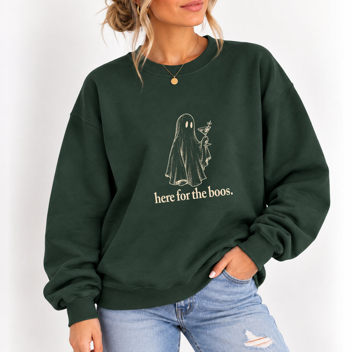 Woman wearing the Here for the Boos crewneck sweatshirt in Forest Green with jeans