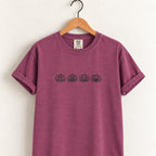 Jack-o-lantern embroidered tee in Berry on a wooden hanger