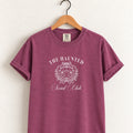 The Haunted Social Club tee in Berry on a wooden hanger