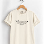 Spooky Season embroidered tee in Ivory on a wooden hanger, black thread lettering with bats