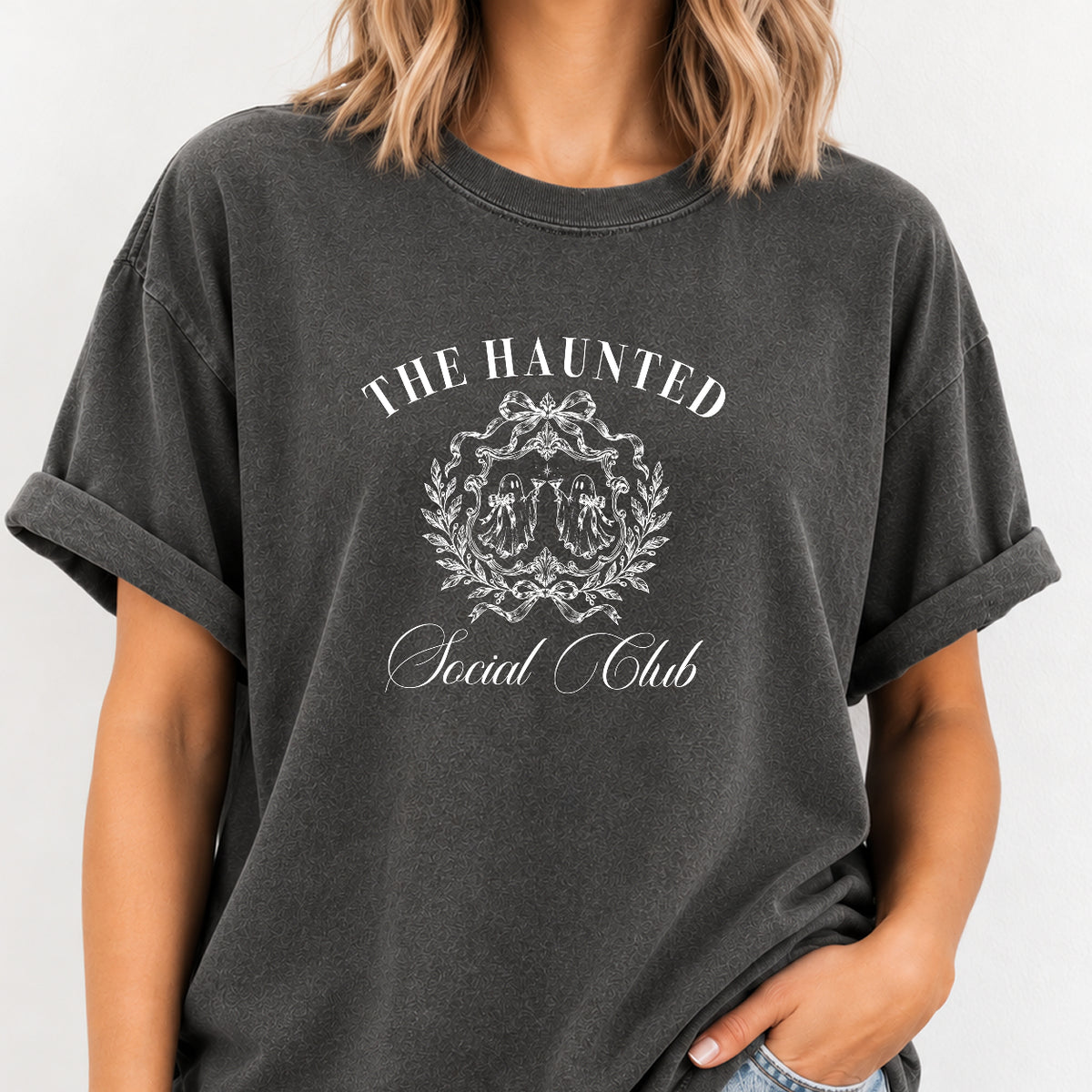 Woman wearing The Haunted Social Club crest tee in Pepper