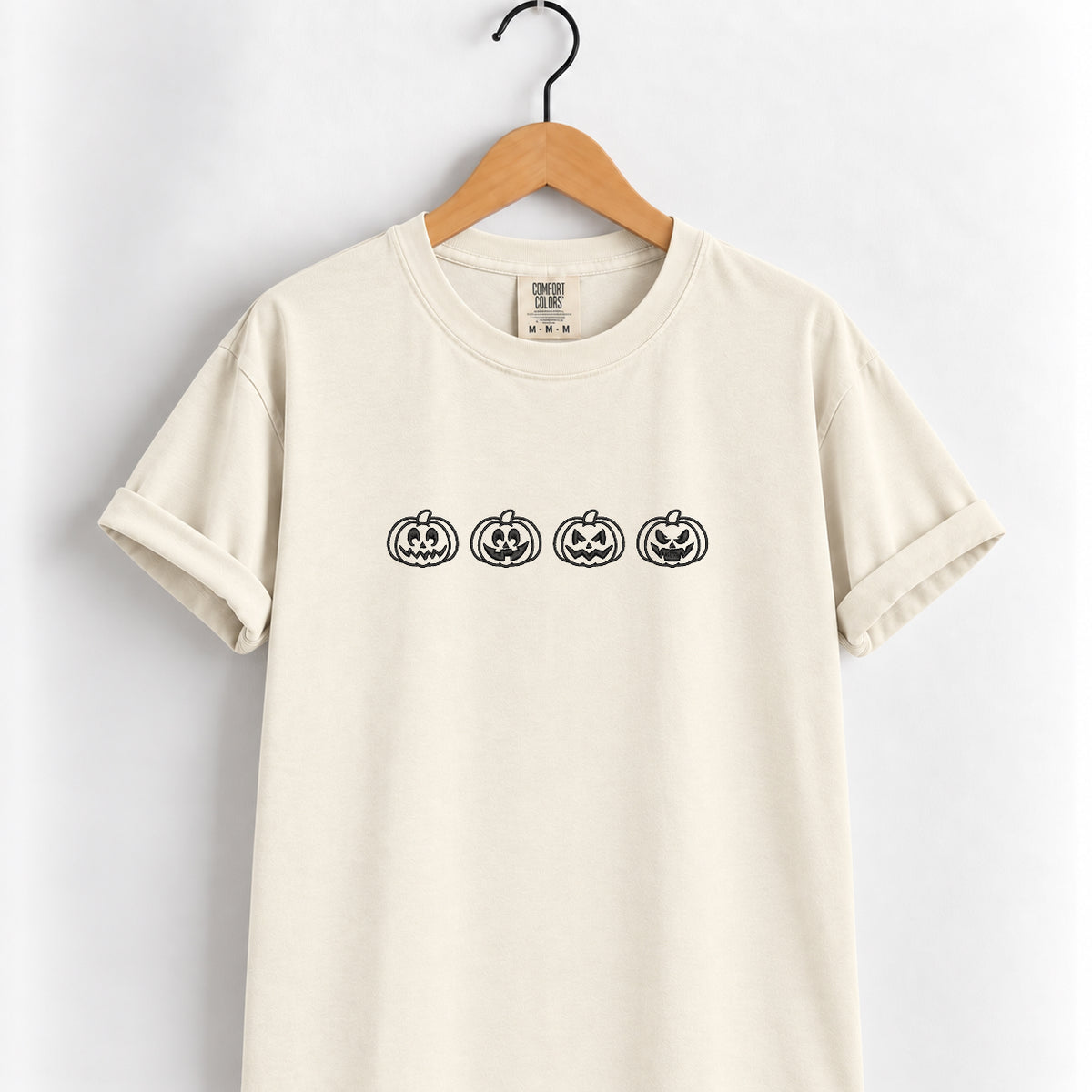 Jack-o-lantern embroidered tee in Ivory on a wooden hanger