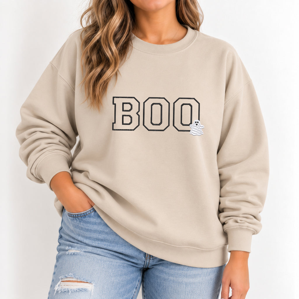 Woman wearing the Boo embroidered crewneck sweatshirt in Sand with jeans