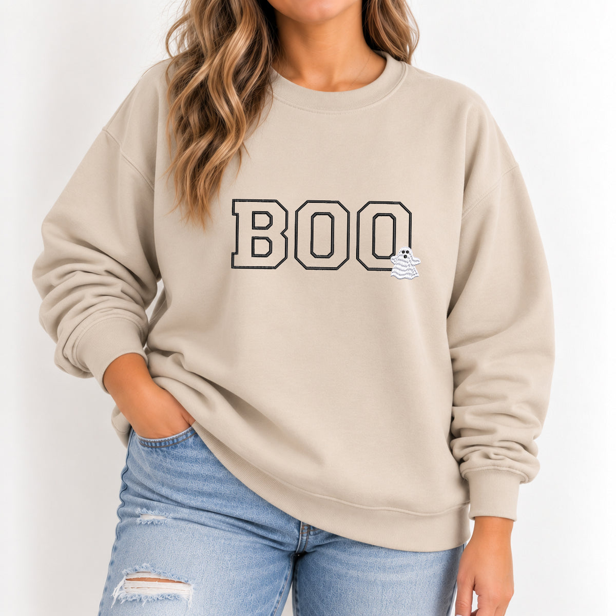 Woman wearing the Boo embroidered crewneck sweatshirt in Sand with jeans