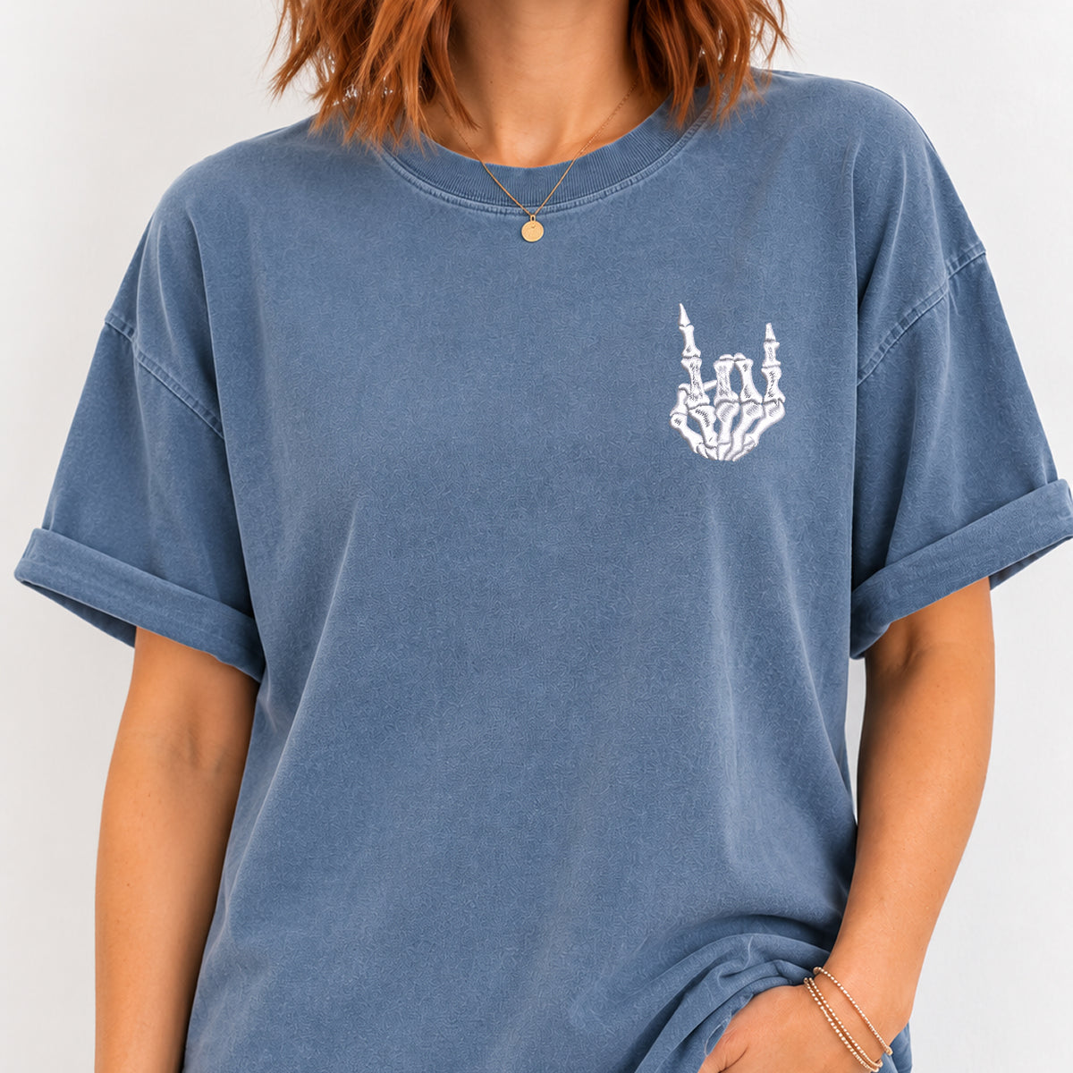 Woman wearing the rock on skeleton hand embroidered tee in Blue Jean