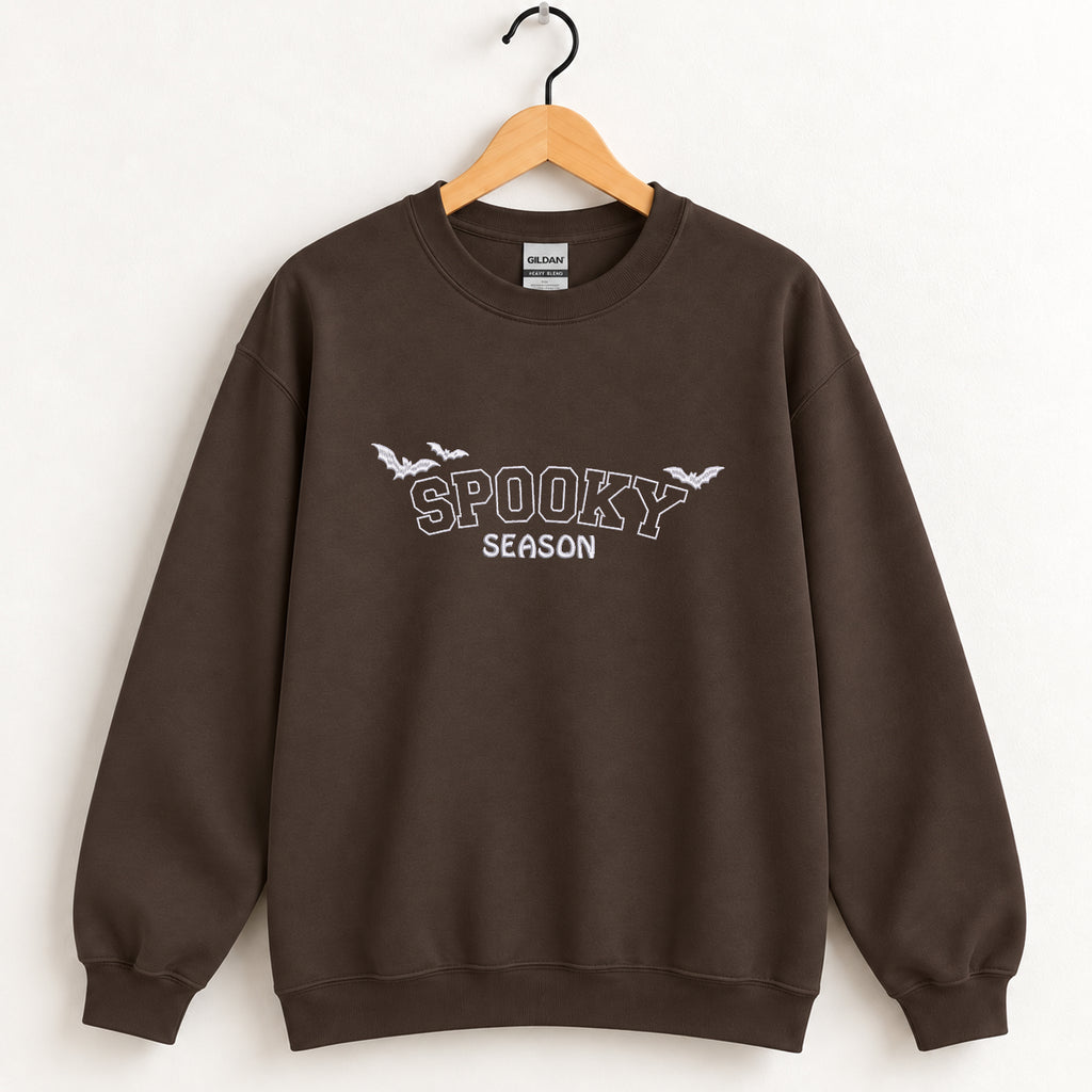 Spooky Season embroidered crewneck sweatshirt in Dark Chocolate on a wooden hanger