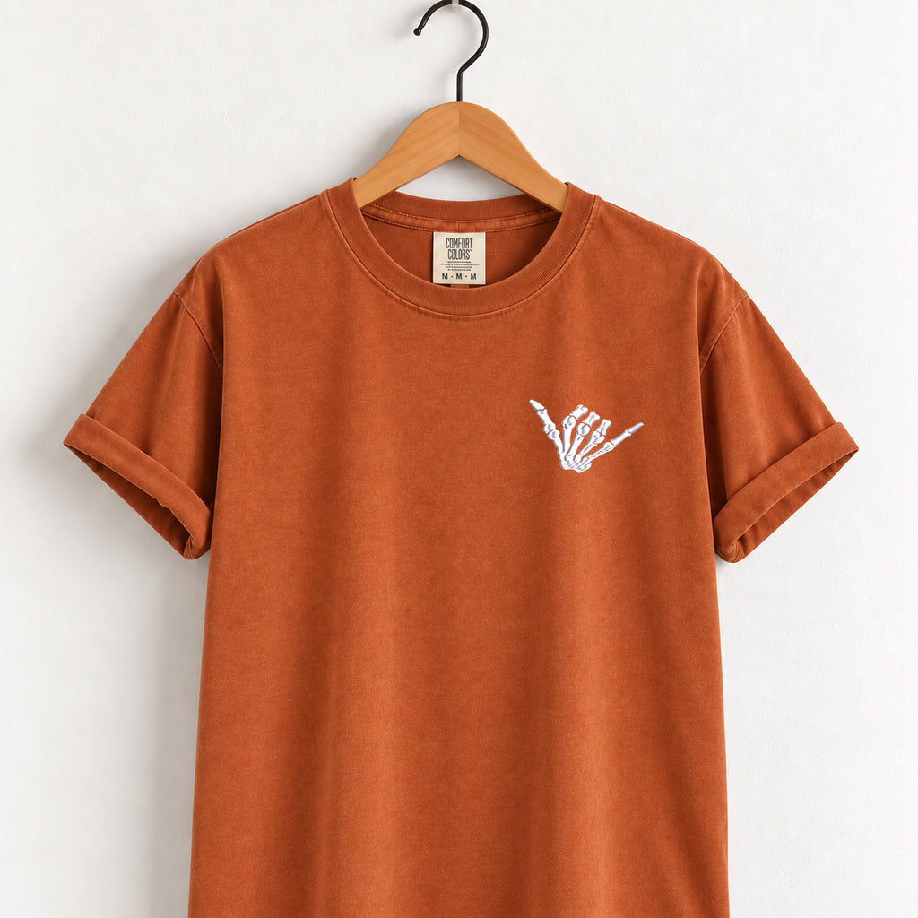 Shaka skeleton hand embroidered tee in Yam on a wooden hanger