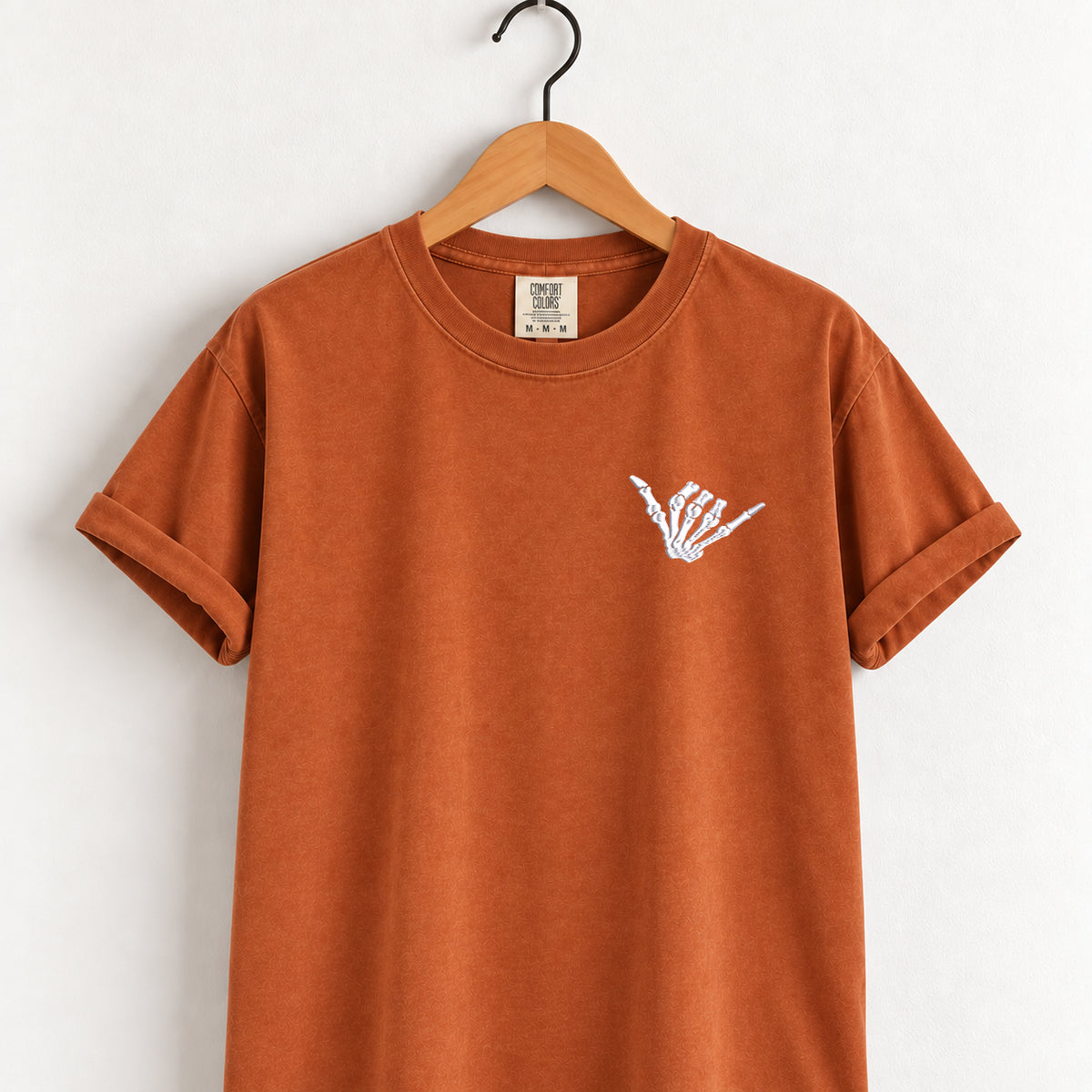 Shaka skeleton hand embroidered tee in Yam on a wooden hanger