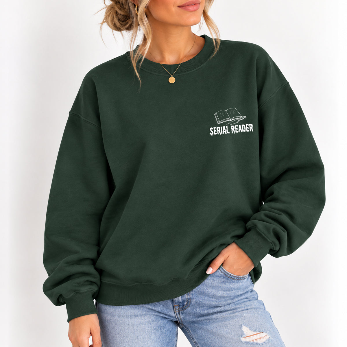 Woman wearing the Serial Reader crewneck sweatshirt in Forest Green with jeans