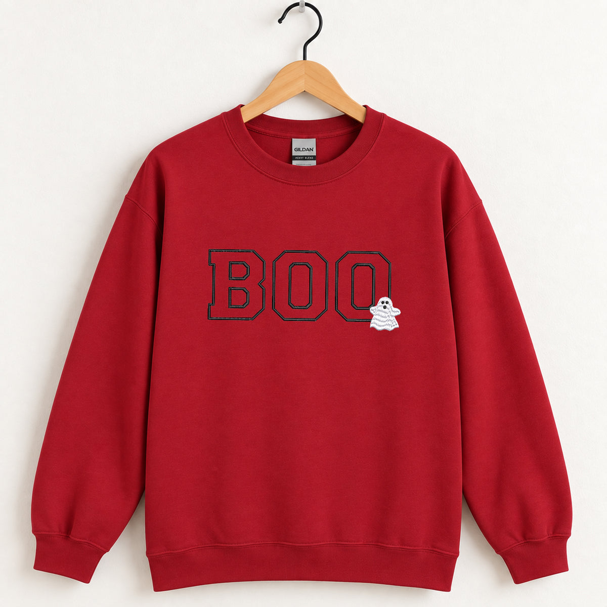 Boo embroidered crewneck sweatshirt in Cardinal Red on a wooden hanger