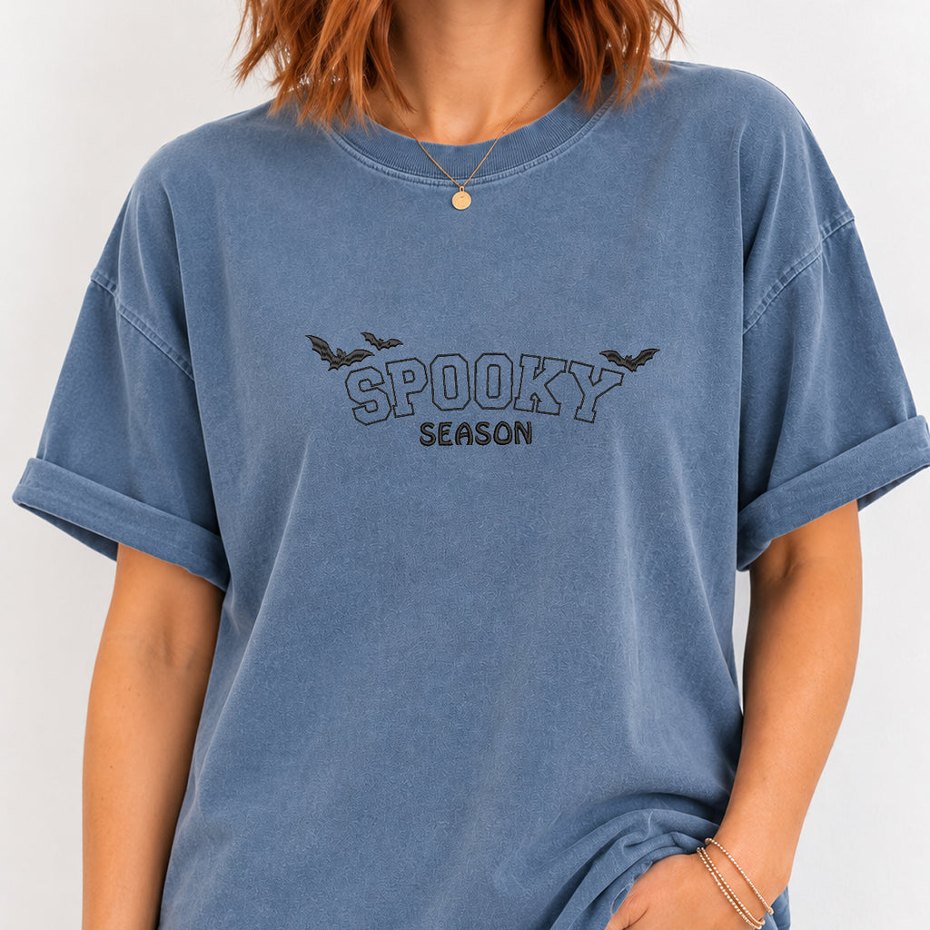 Woman wearing the Spooky Season embroidered bats tee in Blue Jean
