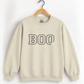 Boo embroidered crewneck sweatshirt in Sand on a wooden hanger, black varsity BOO with a small white ghost