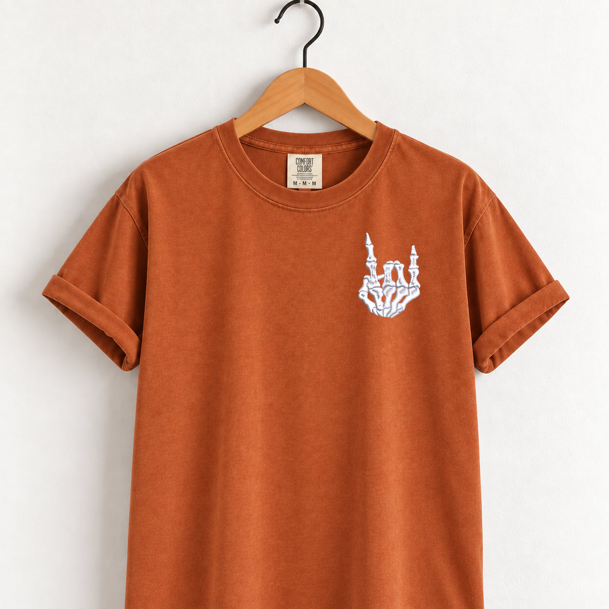 Rock on skeleton hand embroidered tee in Yam on a wooden hanger