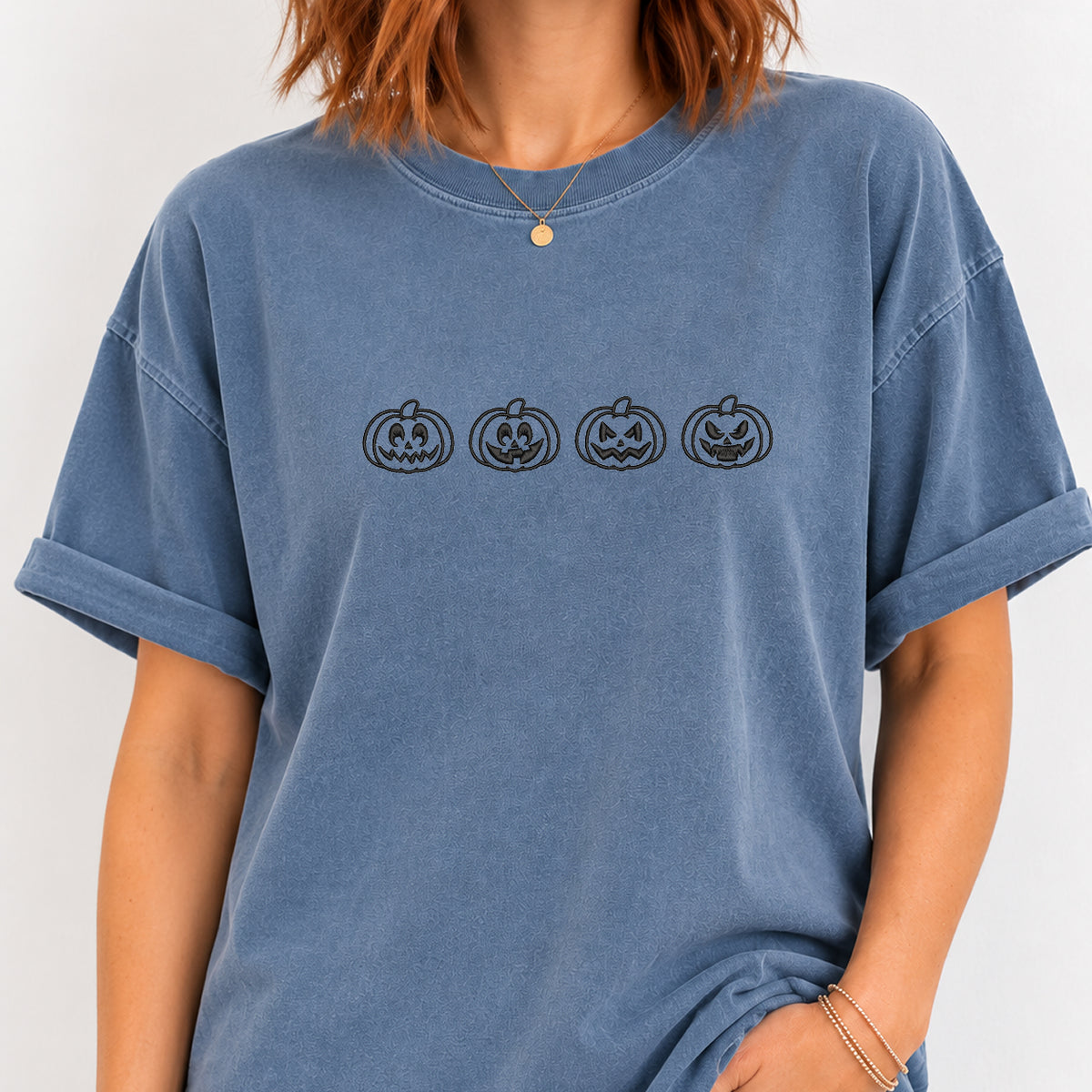 Woman wearing the jack-o-lantern embroidered tee in Blue Jean
