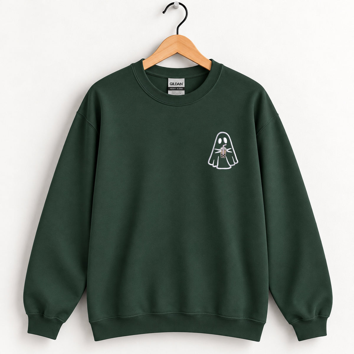 Ghost with a drink embroidered crewneck sweatshirt in Forest Green on a wooden hanger