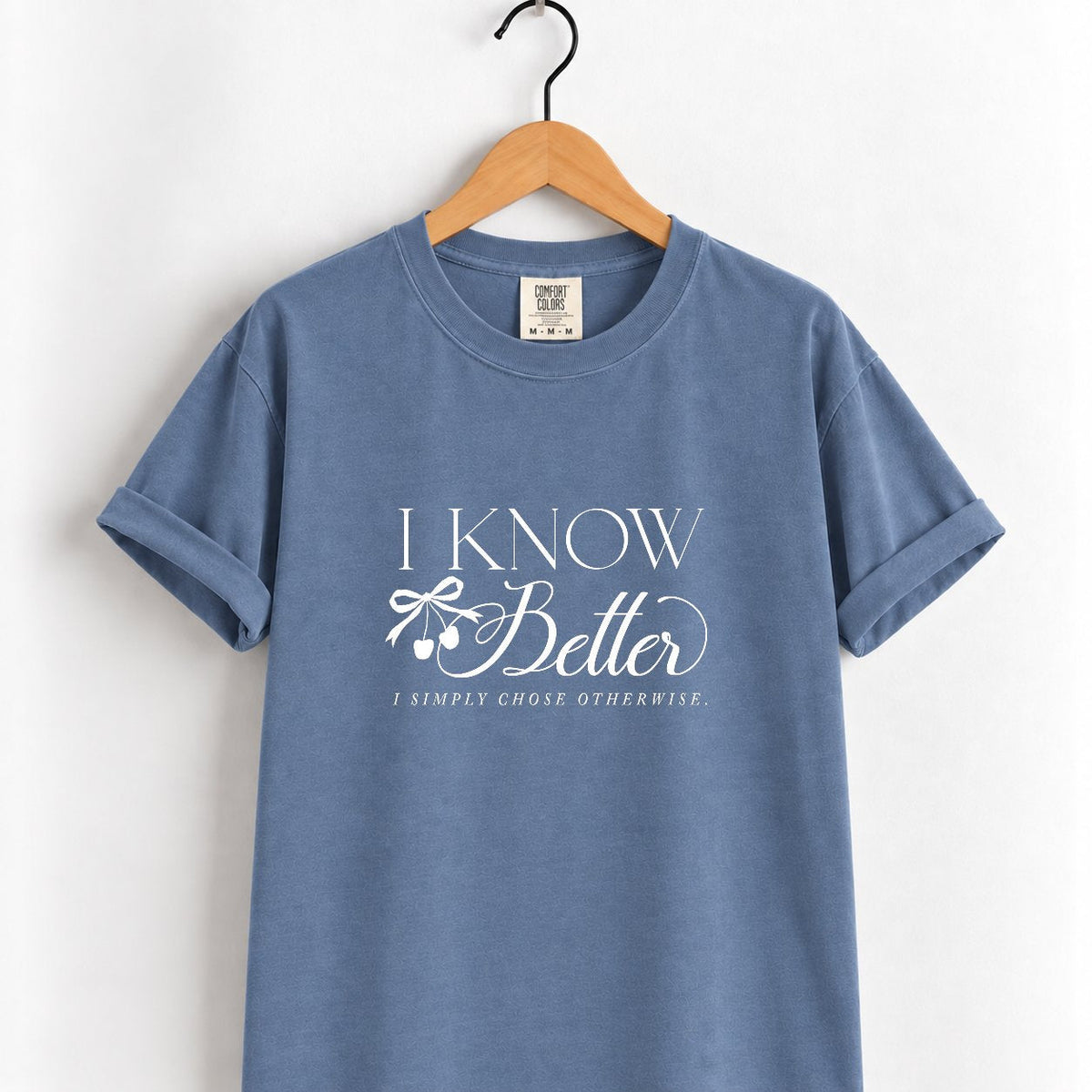 I Know Better, I Simply Chose Otherwise Comfort Colors tee in Blue Jean on a wooden hanger, front view