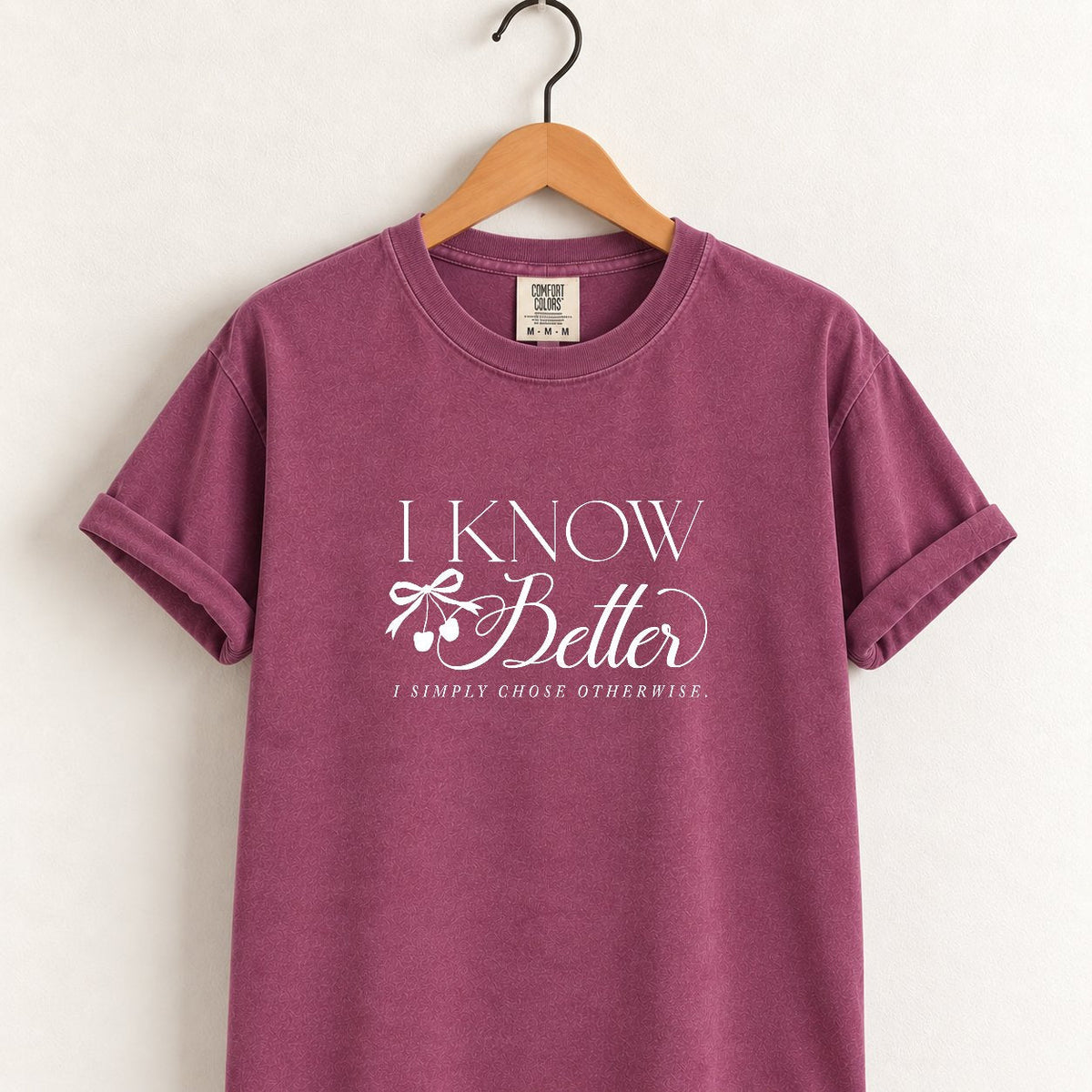 I Know Better, I Simply Chose Otherwise Comfort Colors tee in Berry on a wooden hanger, front view